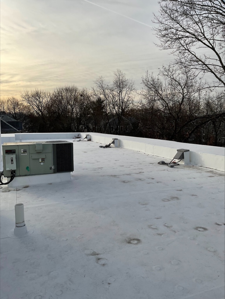photo of a new white roof with raised mechanical equipment