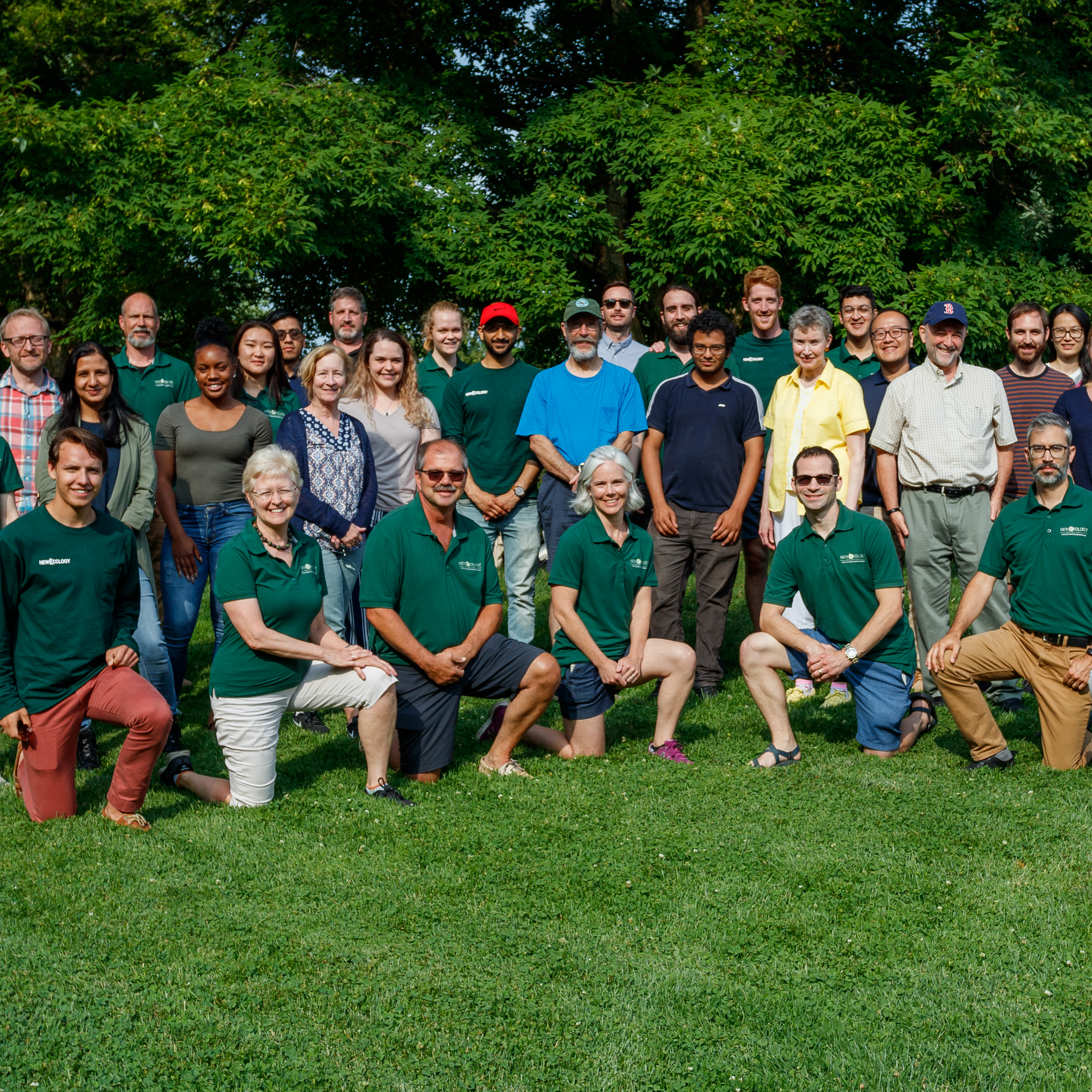 group photo of New Ecology employees outside on green grass