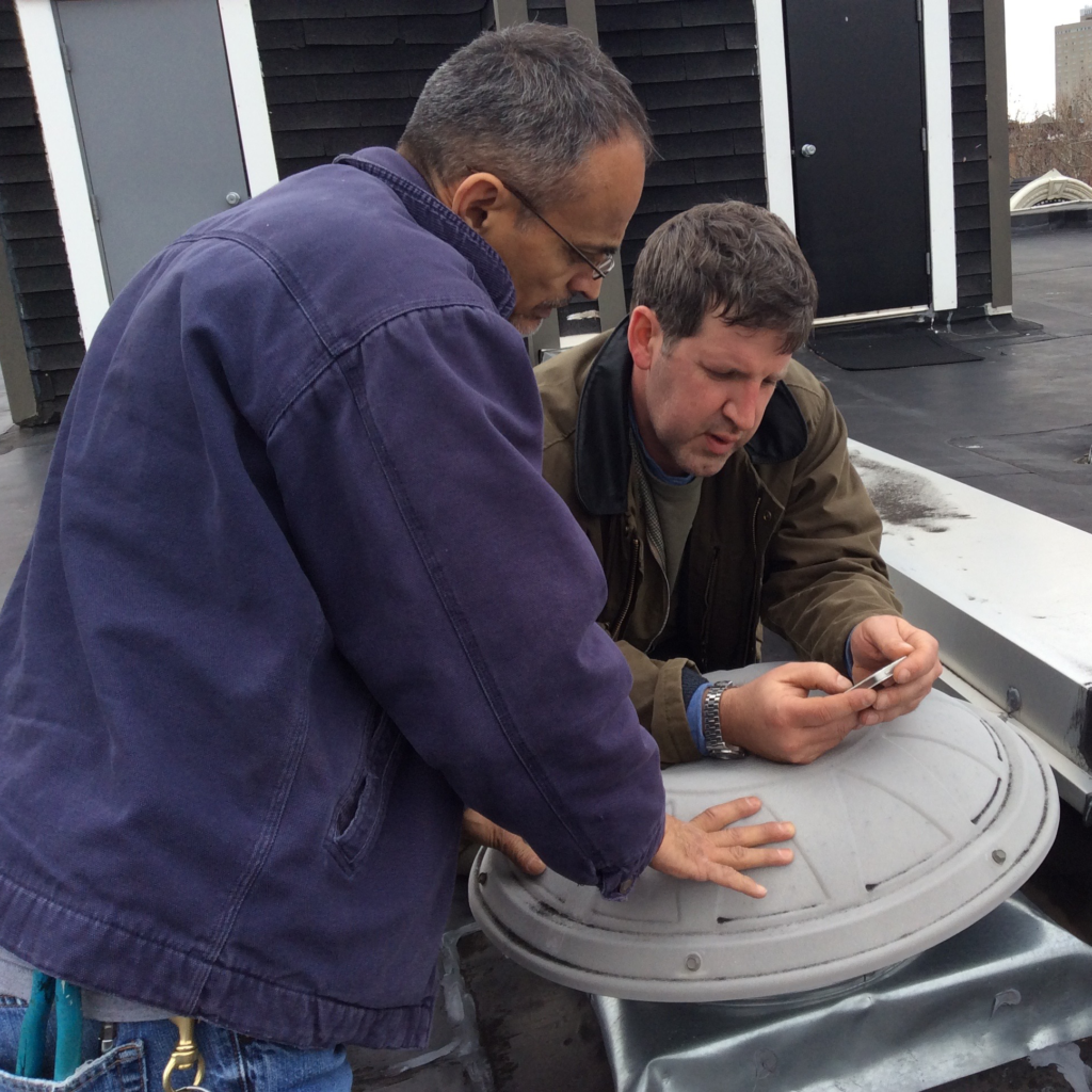 2 men on a roof talking